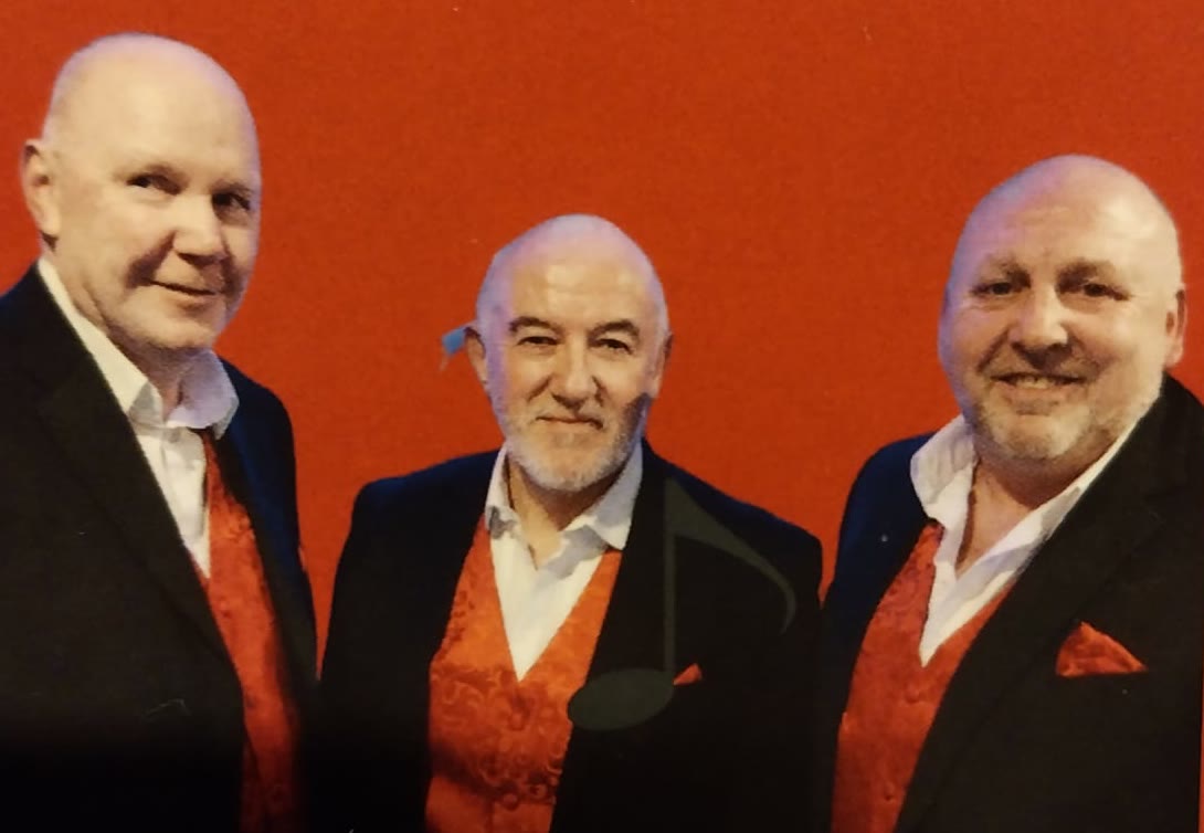 Brian, Peter and Kevin of Main Attraction in their black suits and red waistcoats